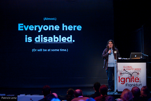 Eric Eggert, at the beginning of his talk, the beamer in the background says (Almost.) Everyone here is disabled. (Or will be at some time.)